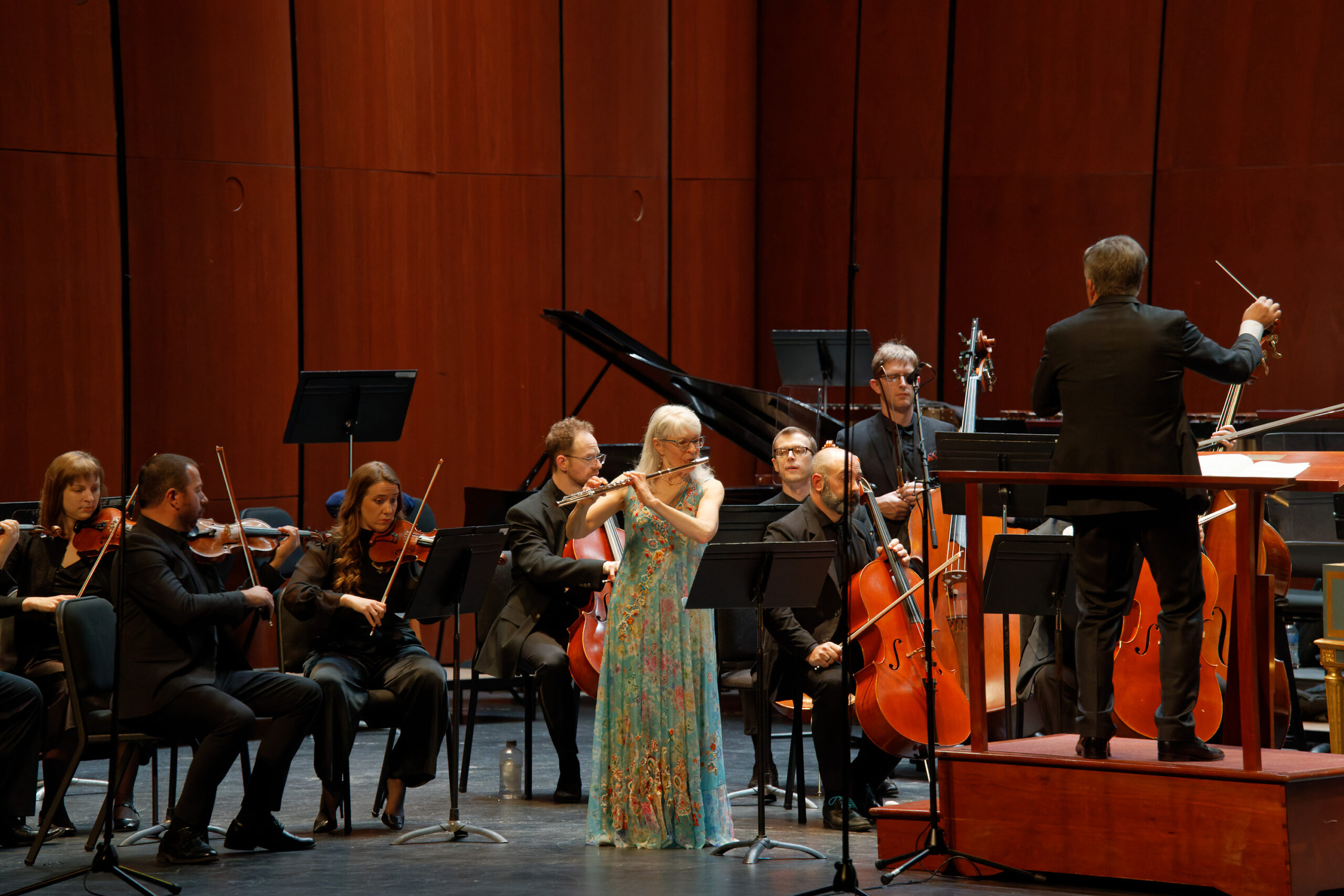flute player in front of orchestra