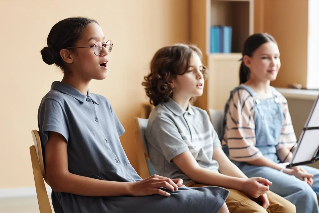 three children singing in a choir